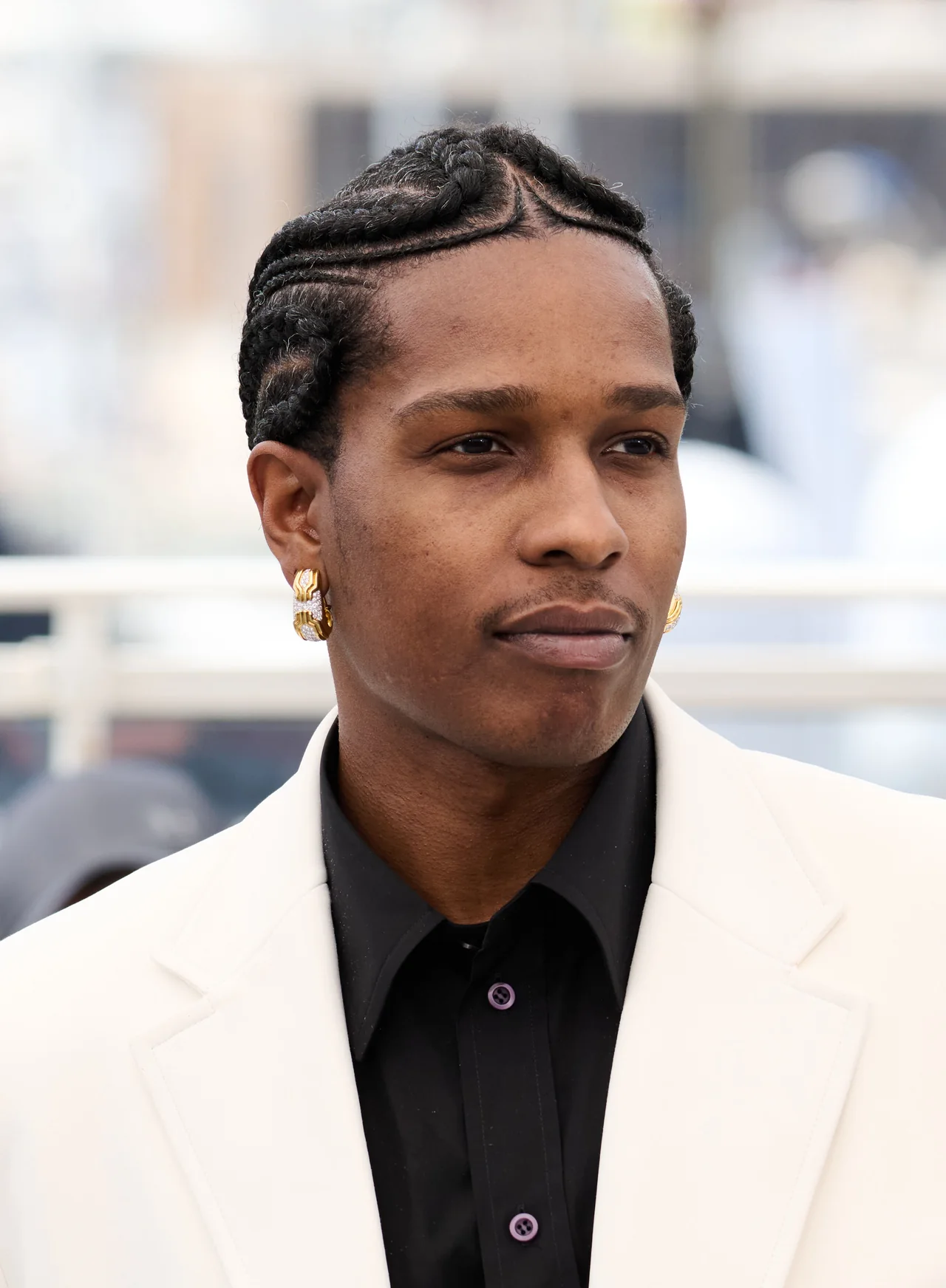 A$AP Rocky in a cream jacket and black shirt at a Cannes photocall in 2025.