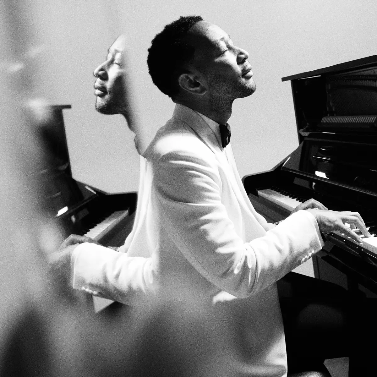 The Muse cover shows John Legend in a white jacket layered over a piano performance.