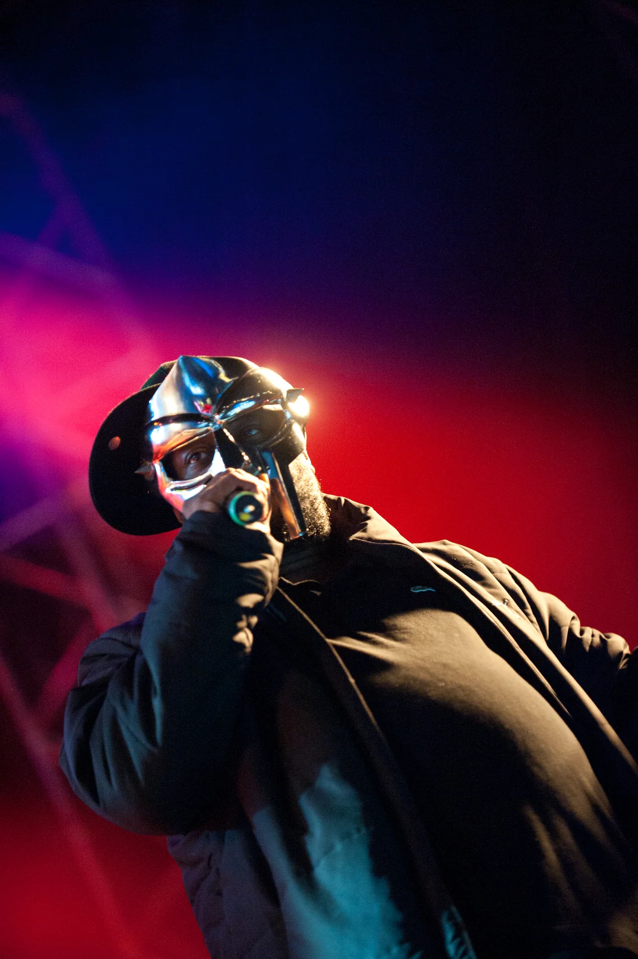 MF DOOM performs in his metal mask under colored stage lights at Hultsfred Festival in 2011.
