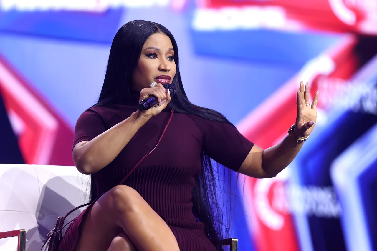 File photo: Nicki Minaj speaks into a microphone at AmericaFest 2025 in Phoenix, not at the Michigan rally.