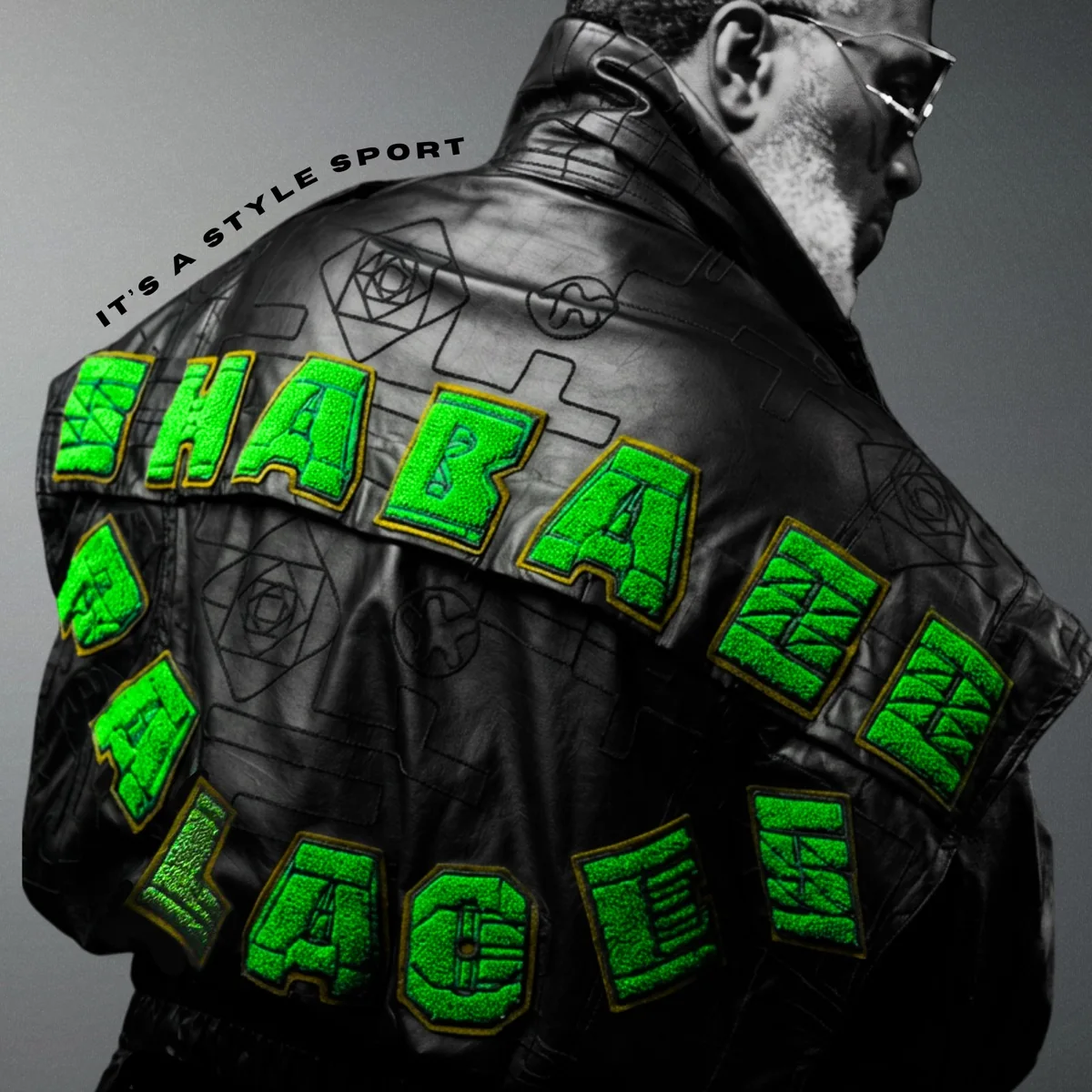 A grayscale close-up of a jacket with bright green Shabazz Palaces lettering and the album title above it.