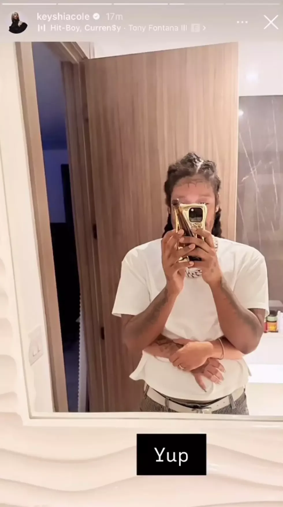 Skrilla takes a mirror selfie while Keyshia Cole stands behind him with her arms around his waist, in an earlier Instagram Story photo.
