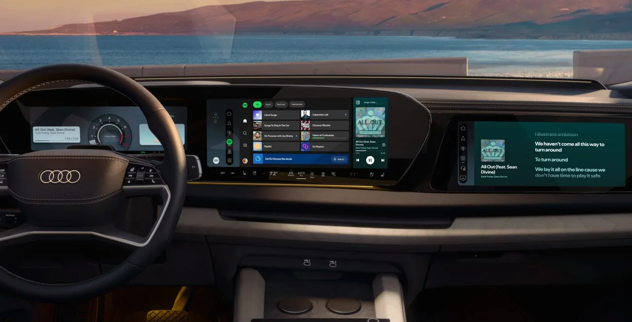 Spotify appears on the center and passenger displays inside an Audi.