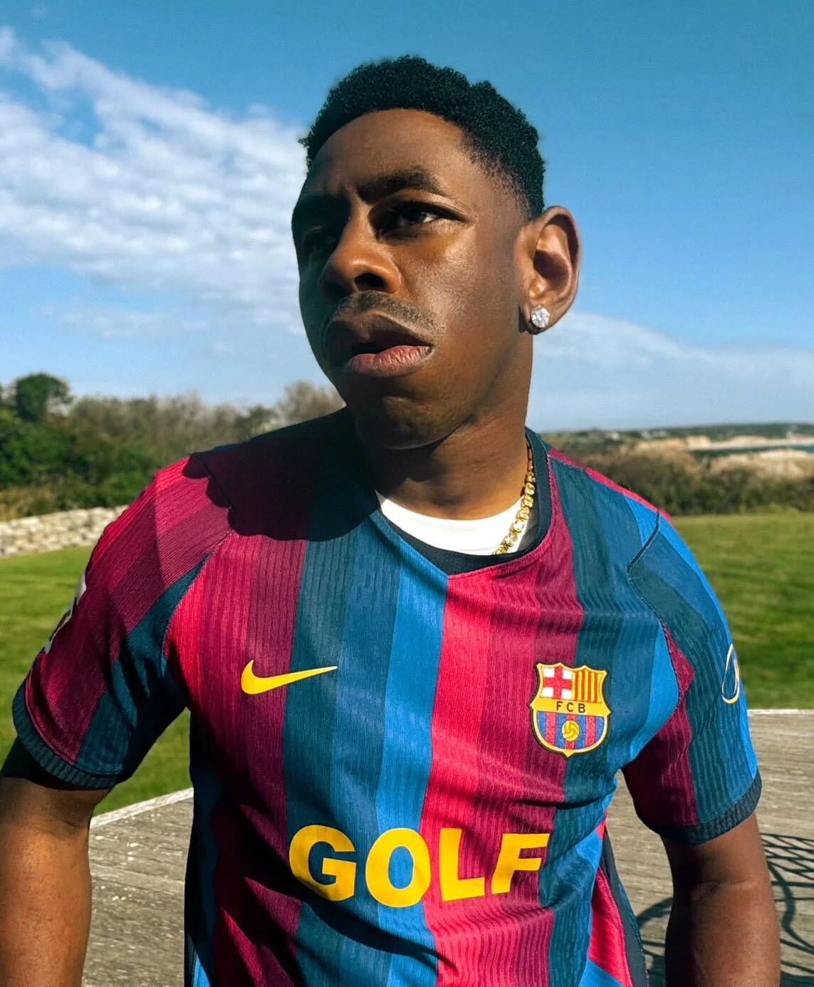 Tyler, The Creator wears the FC Barcelona x GOLF WANG jersey outdoors.