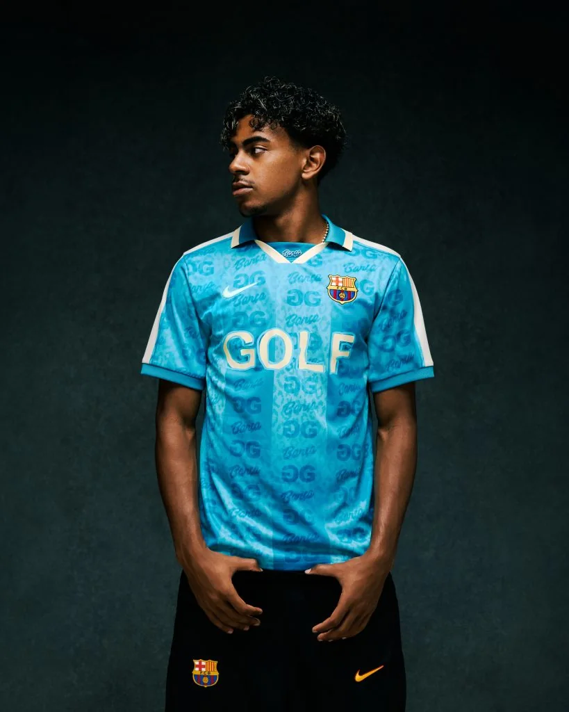 Lamine Yamal models the turquoise FC Barcelona x GOLF WANG jersey.